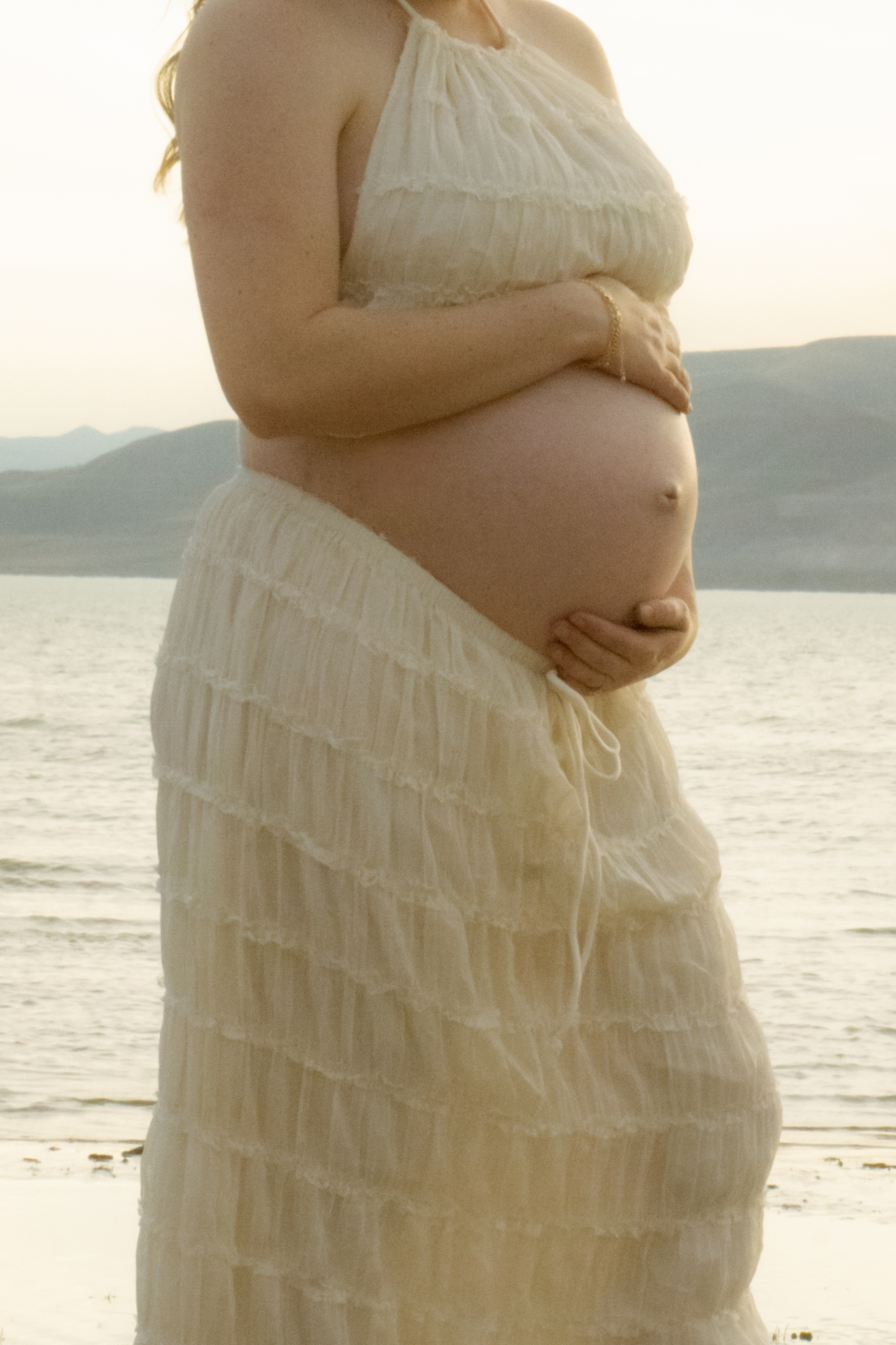 Family — Expectant mother at the water's edge