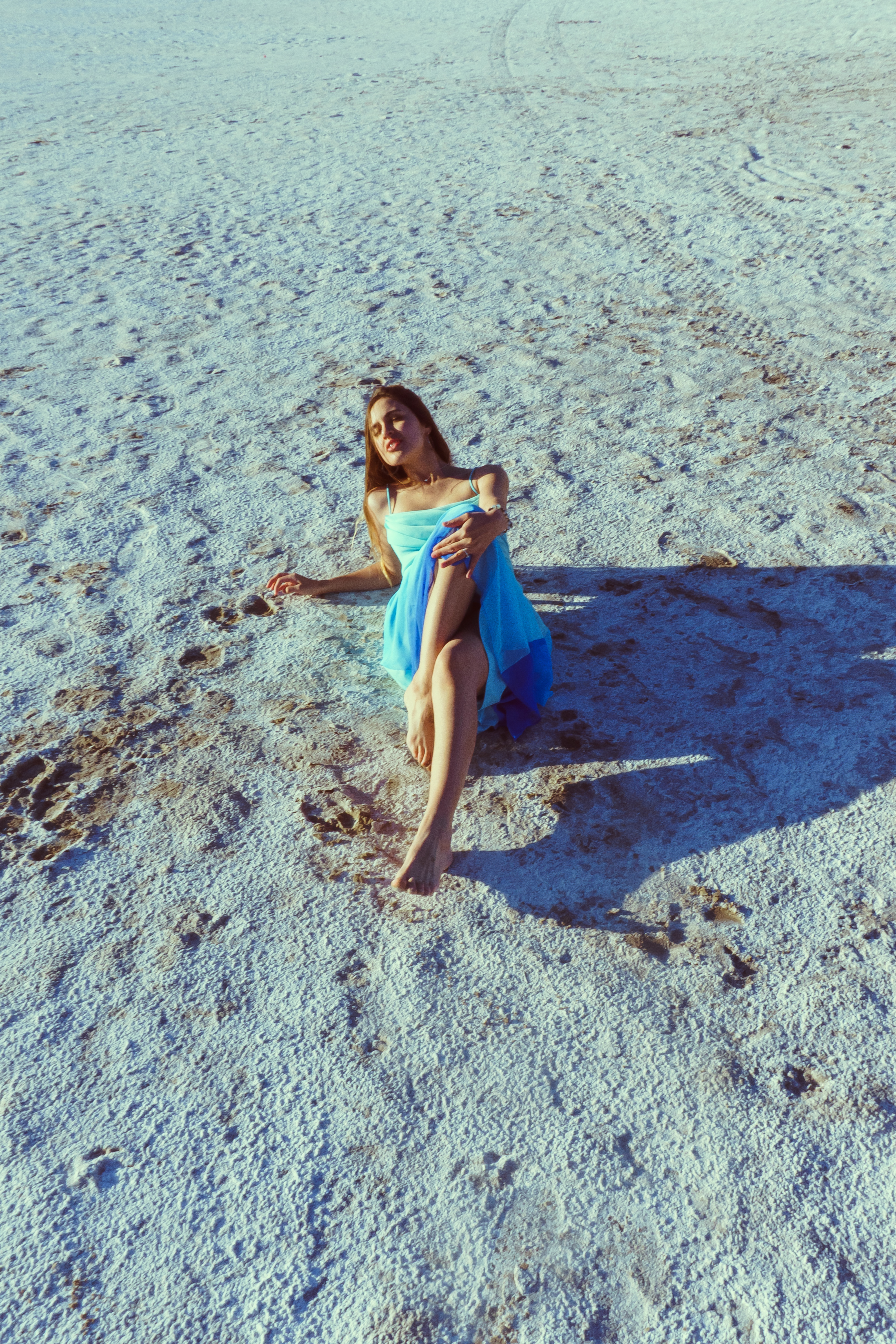 Fashion — Woman in blue dress on the salt flats