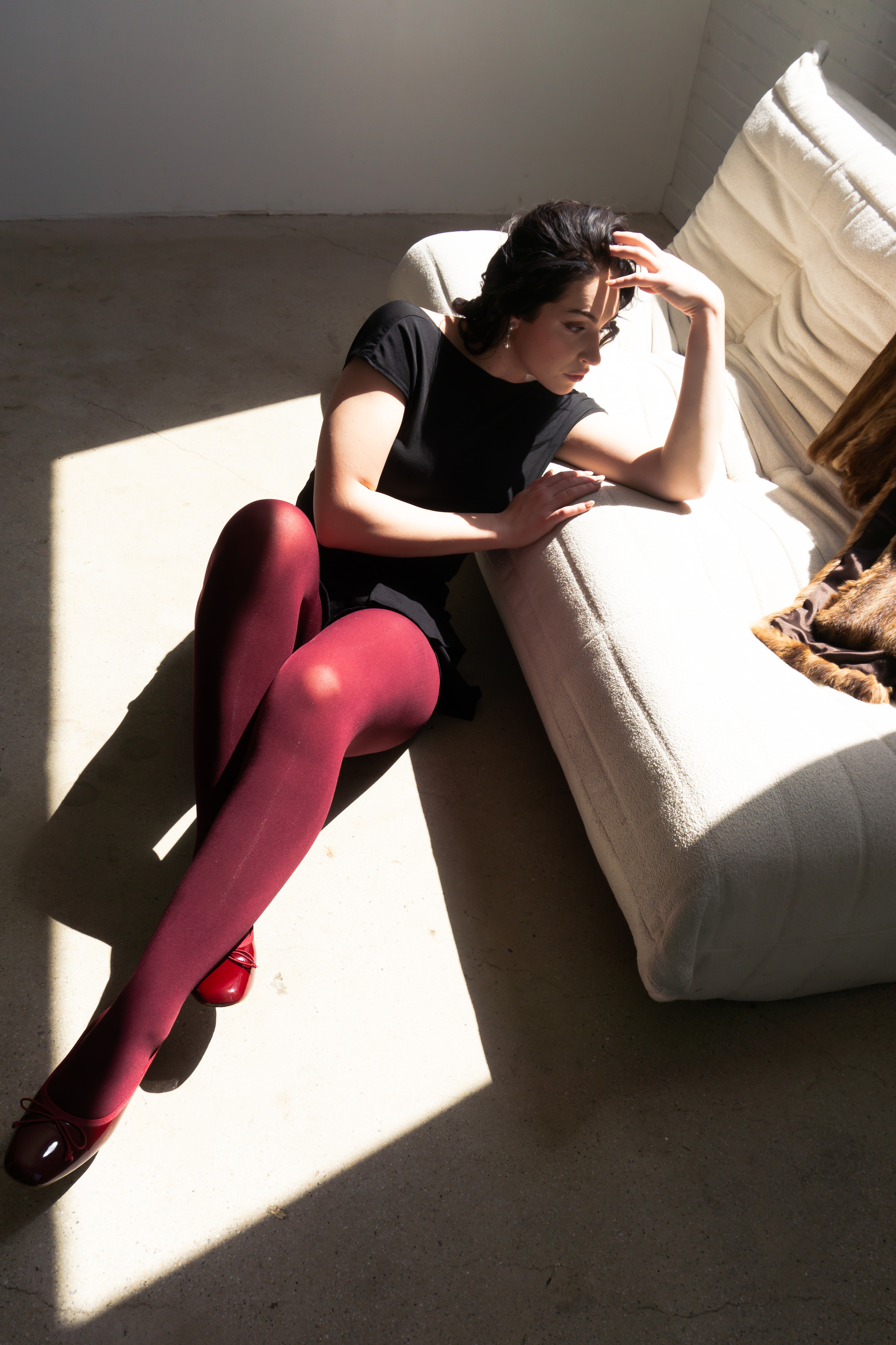 Fashion — Woman on a couch in soft window light