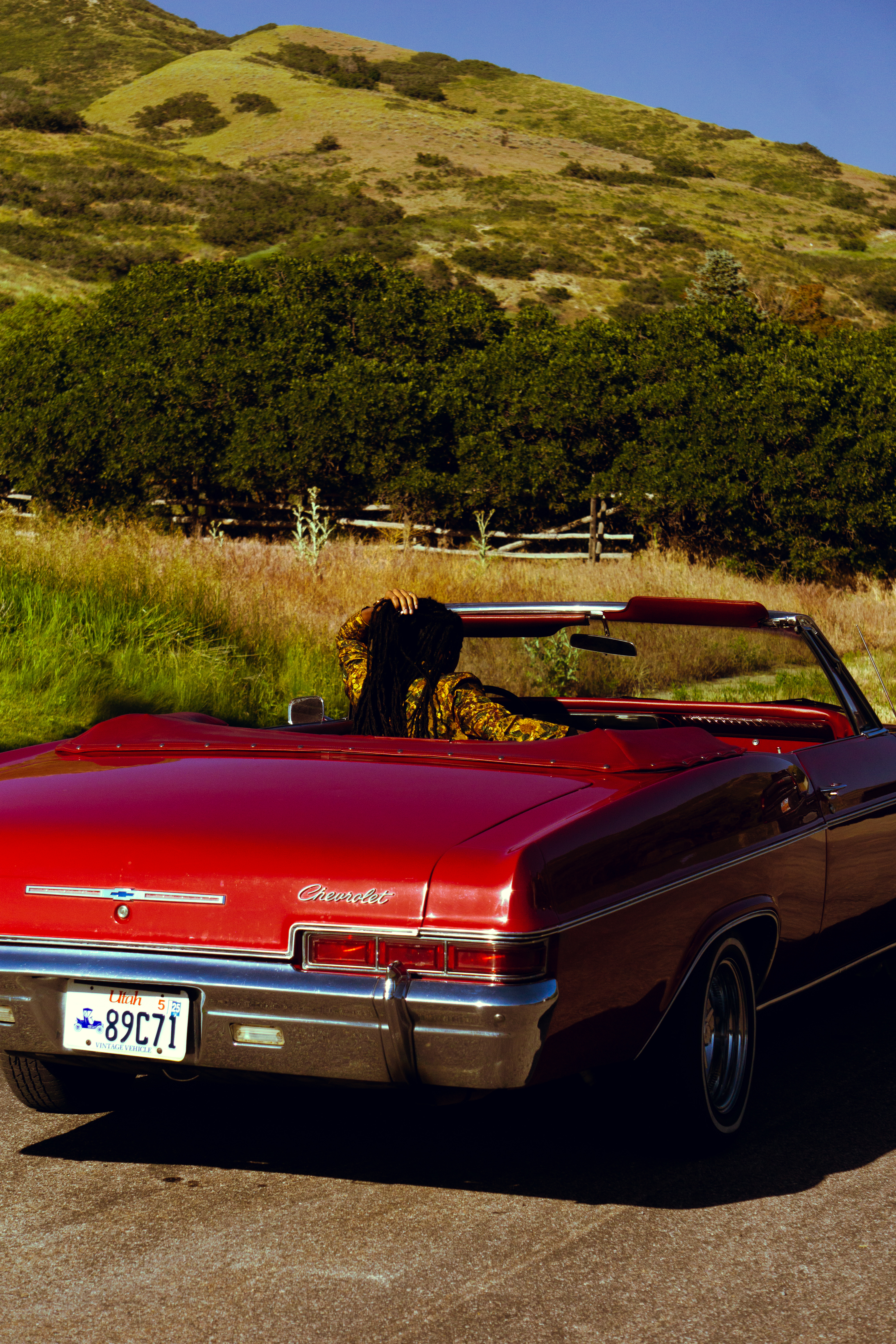 Lifestyle — Red Chevrolet convertible on a winding hill road