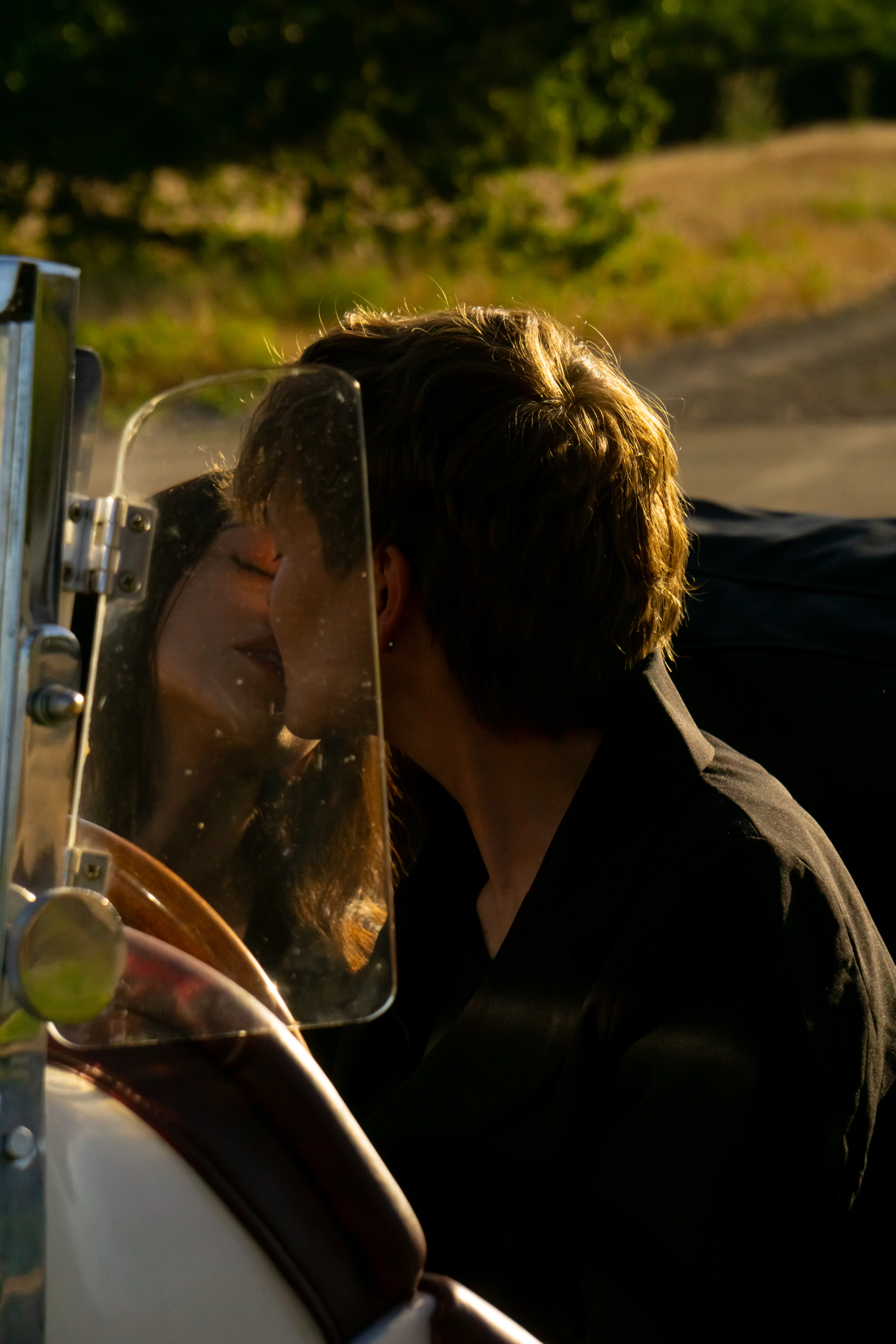 Couples — Sharing a kiss in a vintage convertible
